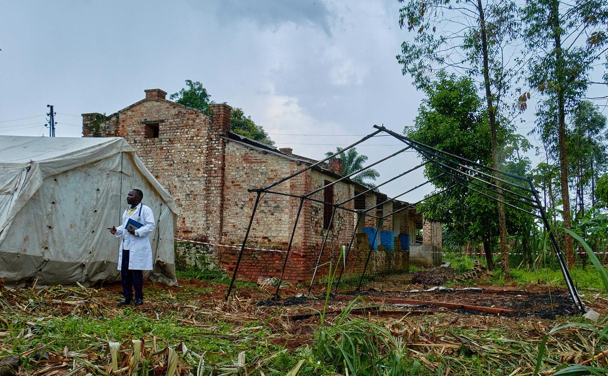 Medical Director of Mungwalu General Hospital Richard Lokudu speaks to Reuters next to the burned remains of a destroyed Médecins Sans Frontières (MSF) emergency isolation tent at the Mongbwalu General Referral Hospital as aid agencies intensify efforts to contain an Ebola outbreak caused by the Bundibugyo virus in Mongbwalu, Djugu Territory of Ituri province, Democratic Republic of Congo, May 23, 2026. REUTERS/Gradel Muyisa Mumbere