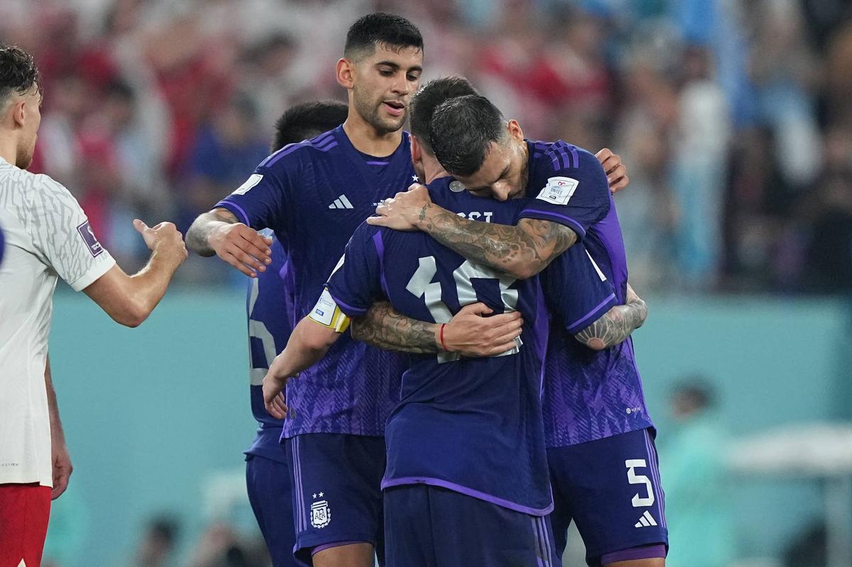  Argentina forward Lionel Messi (10) and midfielder Leandro Paredes (5) embrace. Danielle Parhizkaran-USA TODAY Sports