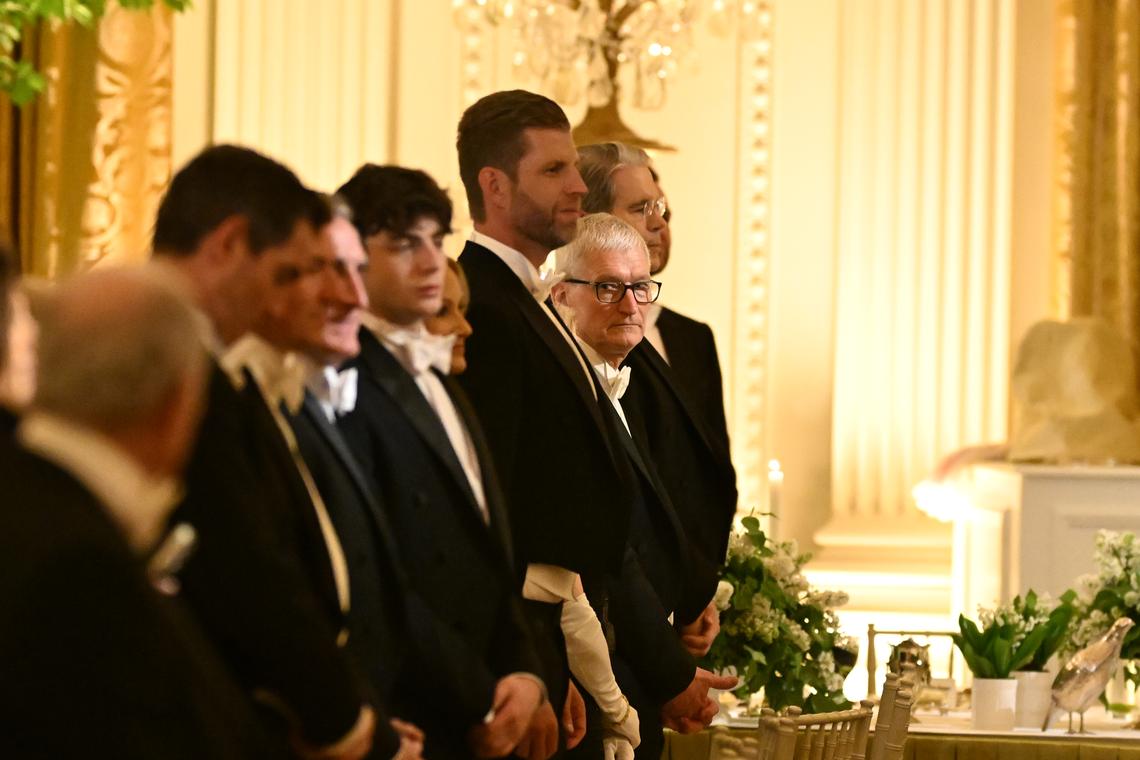 Tim Cook, the CEO of Apple, looks down a line of attendees during a state dinner hosted by President Donald Trump and first lady Melania Trump for King Charles III and Queen Camilla of the United Kingdom in the East Room of the White House in Washington, on Tuesday, April 28, 2026. (Kenny Holston/The New York Times)