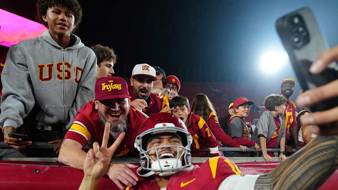  Nov 29, 2025; Los Angeles, California, USA; Southern California Trojans quarterback Jayden Maiava (14) poses with fans after the game against the UCLA Bruins at United Airlines Field at Los Angeles Memorial Coliseum. Mandatory Credit: Kirby Lee-Imagn Images | Kirby Lee-Imagn Images 