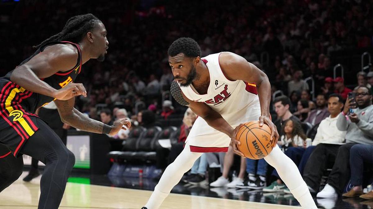  Apr 12, 2026; Miami, Florida, USA; Miami Heat forward Andrew Wiggins (22) looks to drive against Atlanta Hawks guard Keaton Wallace (2) during the second half at Kaseya Center. Mandatory Credit: Jim Rassol-Imagn Images | Jim Rassol-Imagn Images 