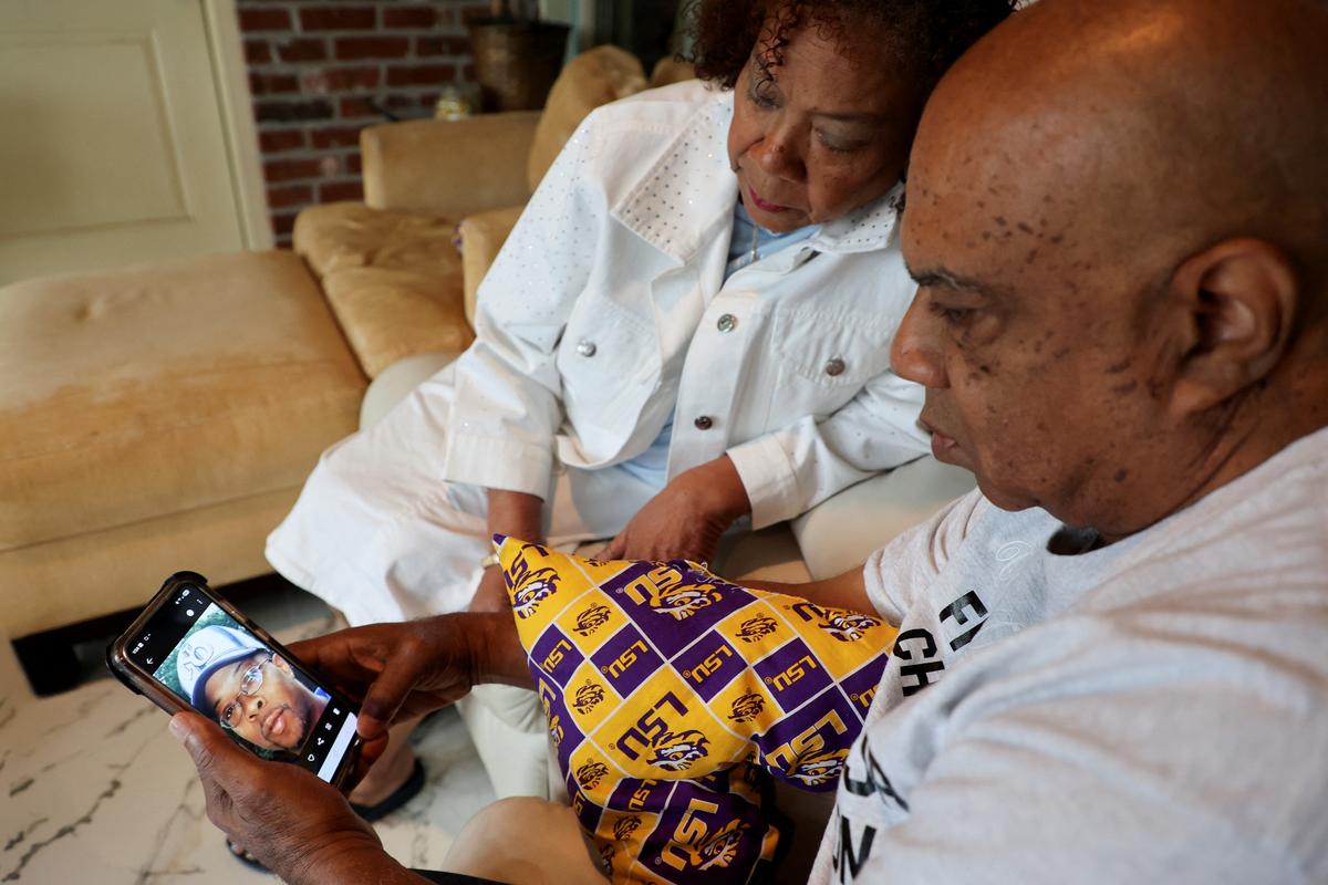 Cynthia and Nelson Wells Sr. look at a photo of their son Nelson Wells Jr., who has been imprisoned in China since 2014, at their home in Haughton, Louisiana, U.S. April 30, 2026. REUTERS/Evan Garcia