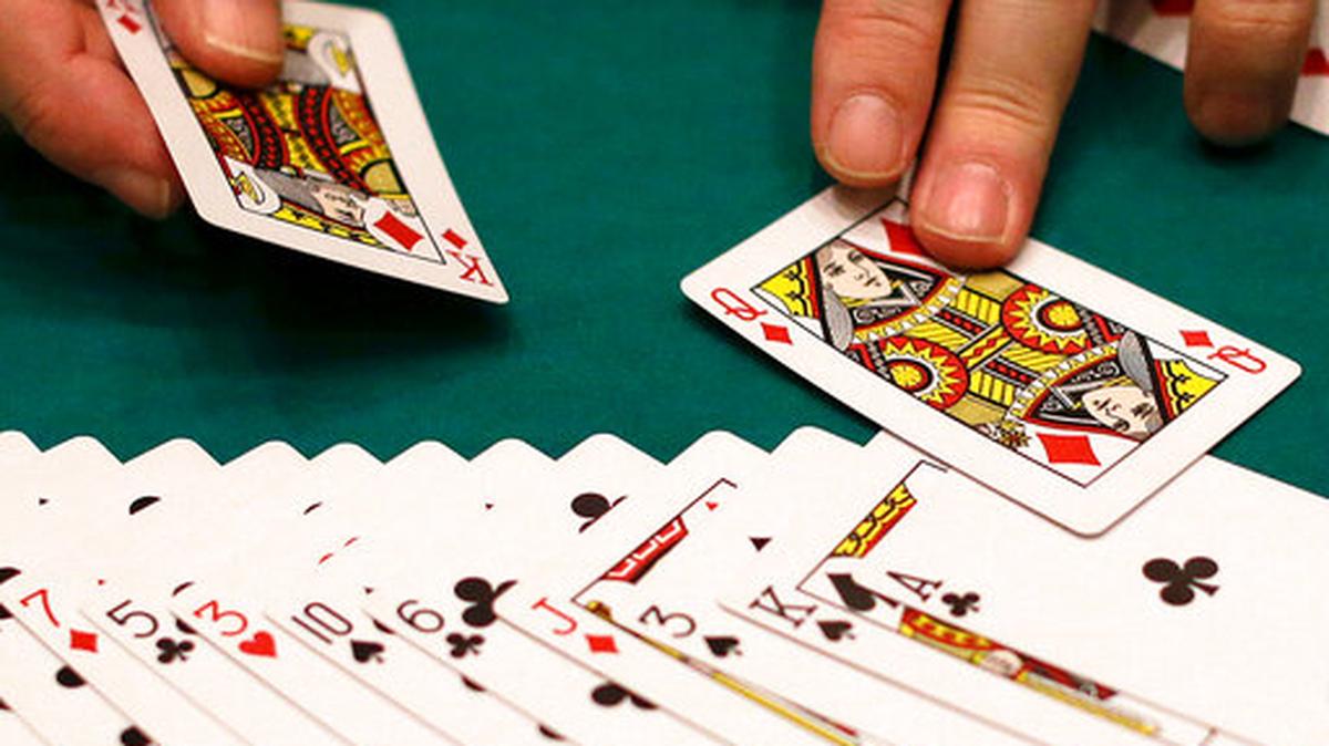 FILE - In this Wednesday, Feb. 27, 2013 file photo, a dealer resets a deck of cards at a casino in Las Vegas. A Cornell University study released on Wednesday, July 17, 2019, created a card game that literally stacked the deck in favor of winners. Yet 60% of those winners thought it was fair, even though they were shown how the deck was stacked. Sociologists say the study tells us about privilege and how we perceive fairness.