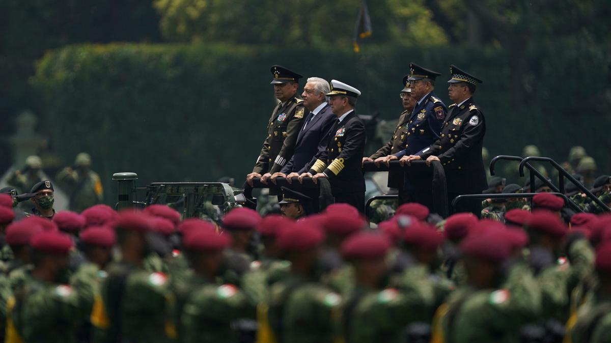 ARCHIVO - El presidente de México, Andrés Manuel López Obrador, al centro, y los comandantes militares, pasan junto a las tropas durante un desfile militar que presenta al nuevo comandante del ejército, en la Ciudad de México, el 13 de agosto de 2021. (Foto AP/Fernando Llano, Archivo)