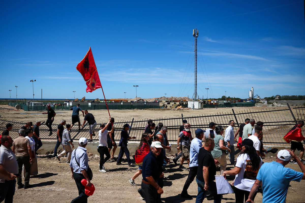 Protesters who say their land has been taken unjustly, tear down the fence where a tourist resort is to be built by the Adriatic coast, in Rrjoll, near Shkodra, Albania, June 13, 2026. REUTERS/Florion Goga
