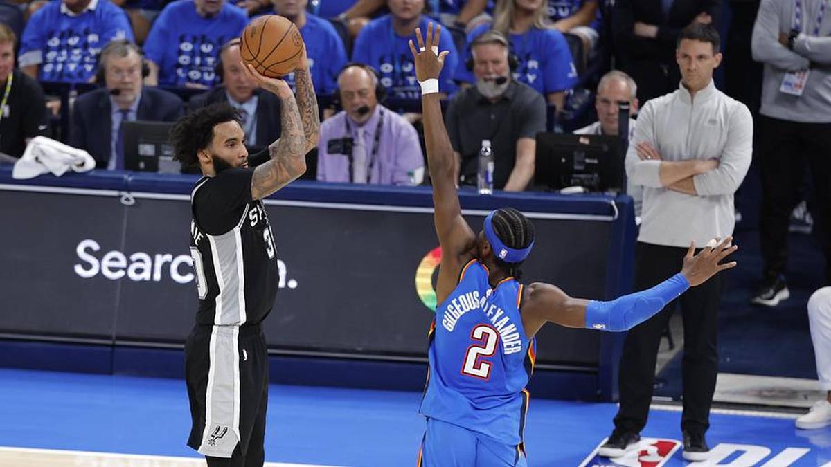  Spurs forward Julian Champagnie shoots against Thunder guard Shai Gilgeous-Alexander during Game 7 of the Western Conference finals. | Alonzo Adams-Imagn Images 
