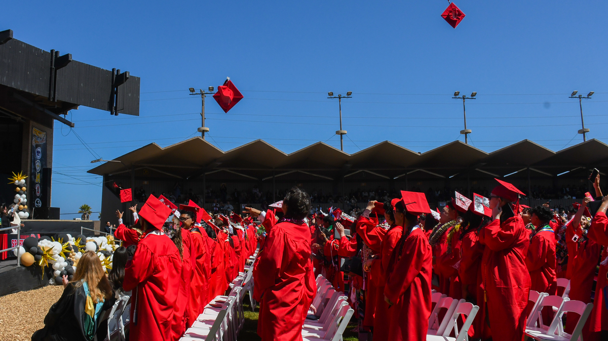 As Friday's graduation ceremony for Seaside High School came to a close, the graduates moved over their tassels then tossed their caps into the air in celebration. (David Timonera - Monterey Herald Correspondent)
