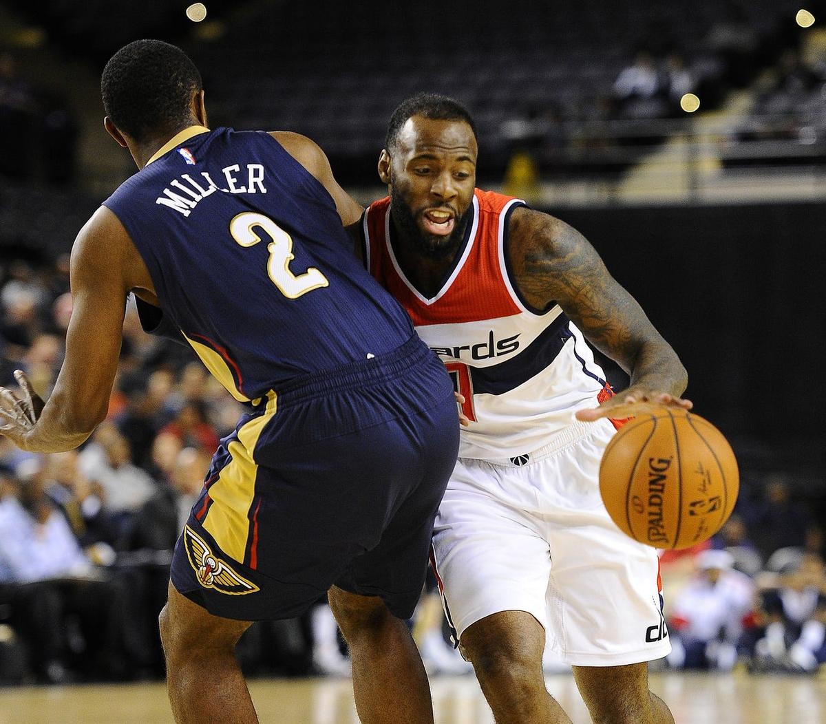Oct 20, 2014; Baltimore, MD, USA; Washington Wizards forward Damion James (7) is fouled by New Orleans Pelicans forward Darius Miller (2) during the second half at Baltimore Arena. Mandatory Credit: Brad Mills-USA TODAY Sports
