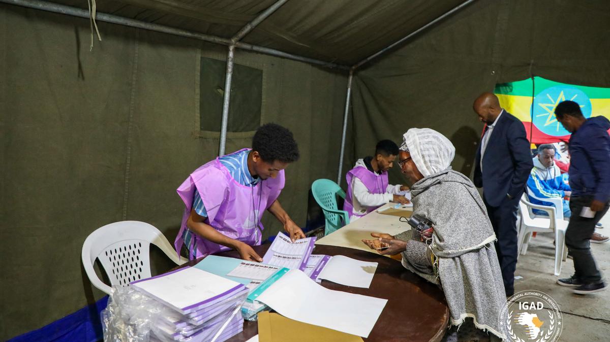 National Election Board of Ethiopia (NEBE) officials process a voter before casting her ballot at a polling station during the parliamentary and regional elections in Addis Ababa, Ethiopia, June 1, 2026. The Intergovernmental Authority on Development (IGAD)/Handout via REUTERS