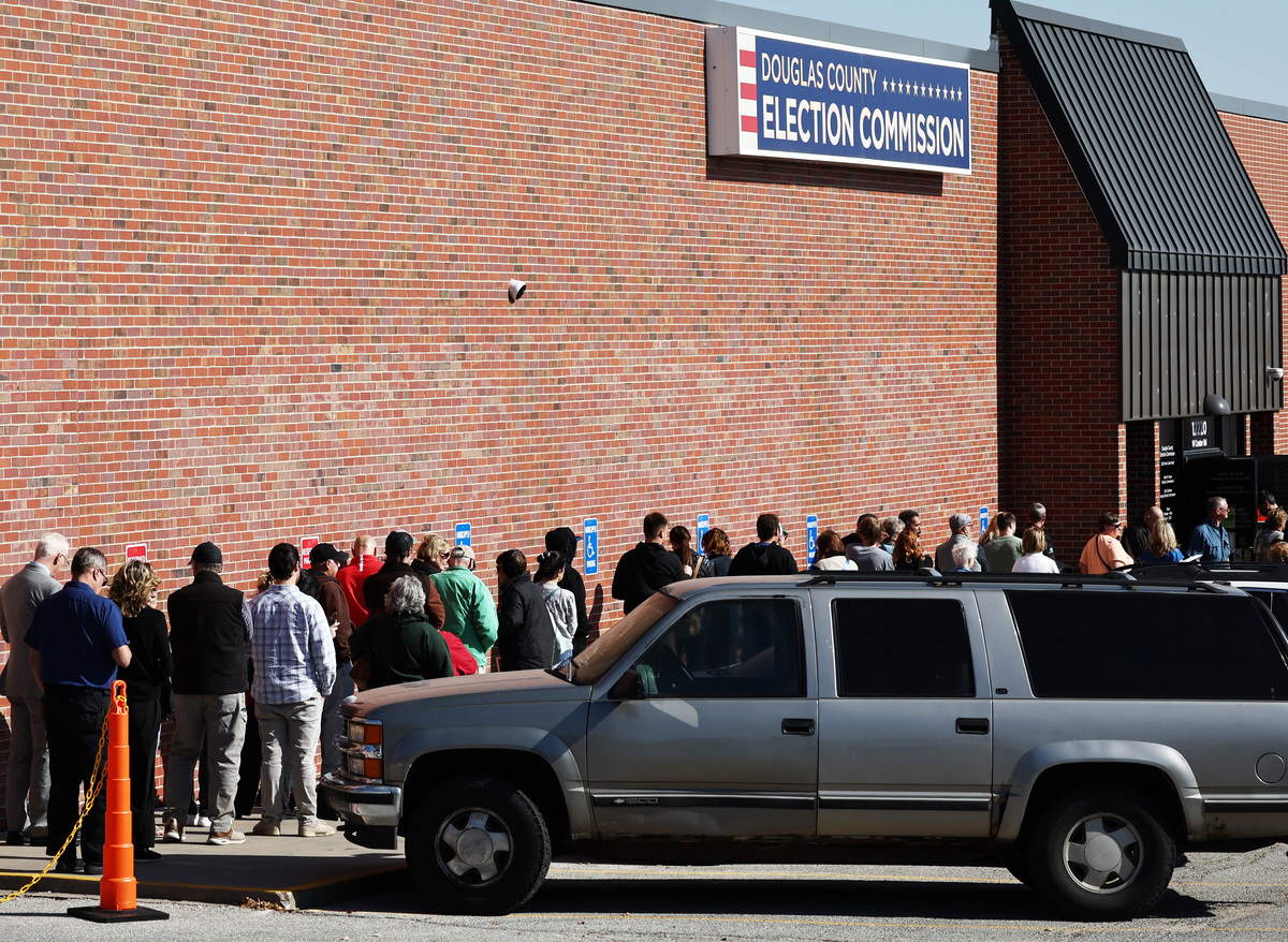  People wait in line to cast early ballots or register to vote outside the Douglas County Election Commission on October 24, 2024, in Omaha, Nebraska. 