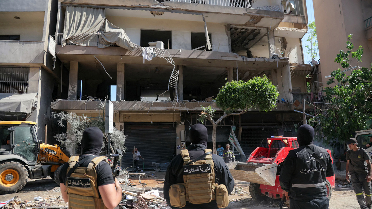 Lebanese army soldiers stand guard as people clear the rubble at the site of an Israeli airstrike that targeted a building in Beirut's southern suburbs on Sunday, June 14, 2026. The office of Israeli Prime Minister Benjamin Netanyahu said on June 14 the military had carried out strikes in Beirut's southern suburbs, known as Dahiyeh, while Lebanese state media said a strike hit the Ghobeiry neighbourhood. A senior Iranian military official warned that Israel's strike would not go "unanswered" by Tehran, according to local media. (Ibrahim Amro/AFP/Getty Images/TNS)