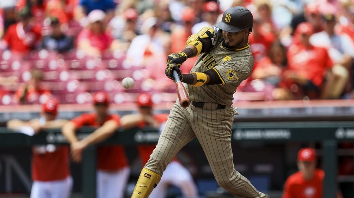 May 23, 2024; Cincinnati, Ohio, USA; San Diego Padres first baseman Luis Arraez (4) hits a single against the Cincinnati Reds in the first inning at Great American Ball Park.