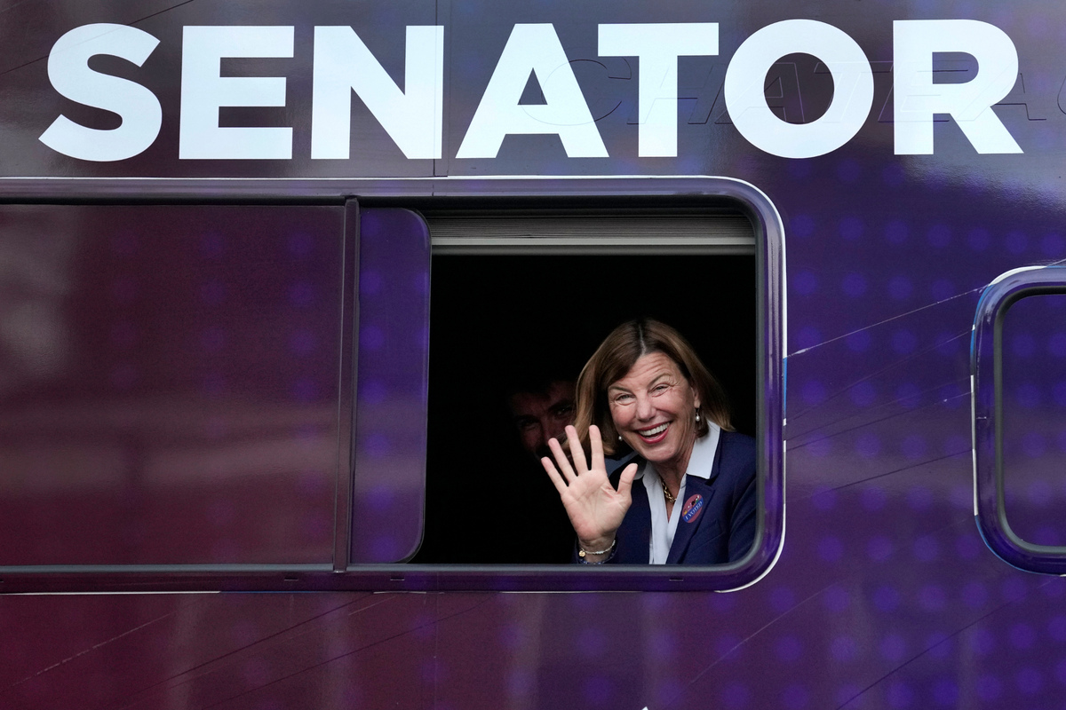 Democratic U.S. Senate candidate Trudy Busch Valentine waves to supporters from her campaign vehicle after casting her ballot Tuesday in Ladue, Mo.