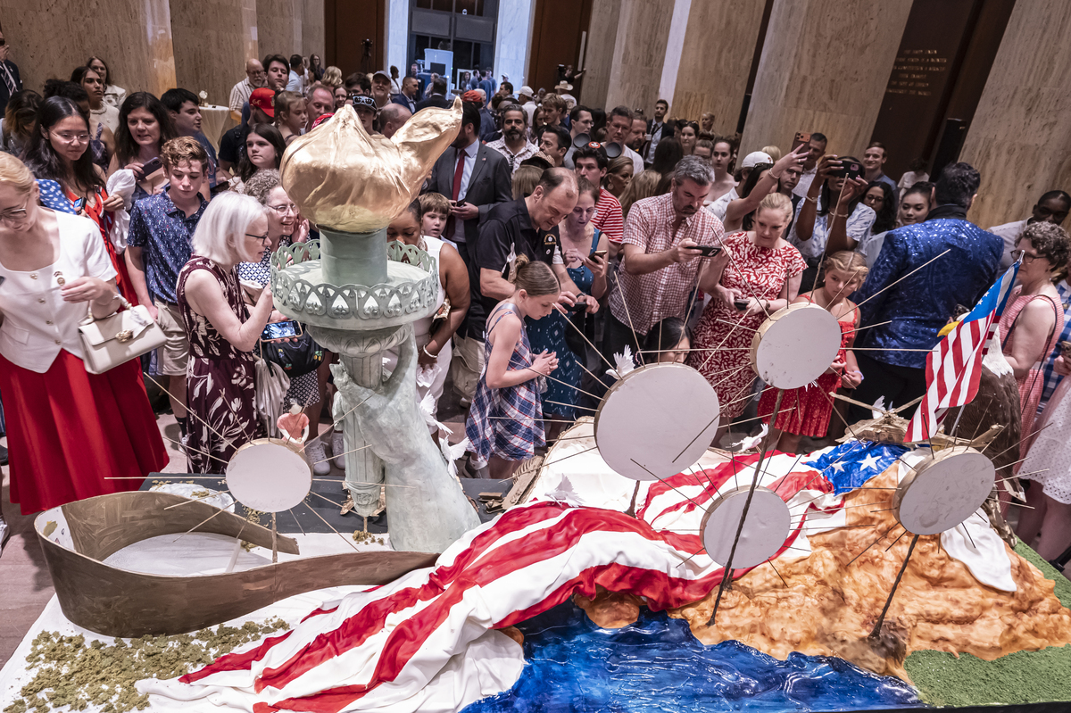 Attendees admire "America's birthday cake" during a ceremony at the Library of Congress in Washington, on Saturday, July 4, 2026. America celebrates the 250th anniversary of its independence today, with people from one end of the country to the other marking the milestone with fireworks, parades and concerts. (Scott Schuman/The New York Times)