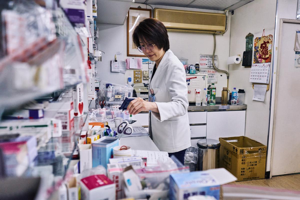 Wang Ming-yua bags medicine at her pharmacy in Taipei, Taiwan on April 9, 2026. Plastic producers in Taiwan have scrambled to secure new supplies since the war in Iran disrupted petrochemical flows and tightened availability. (An Rong Xu/The New York Times)