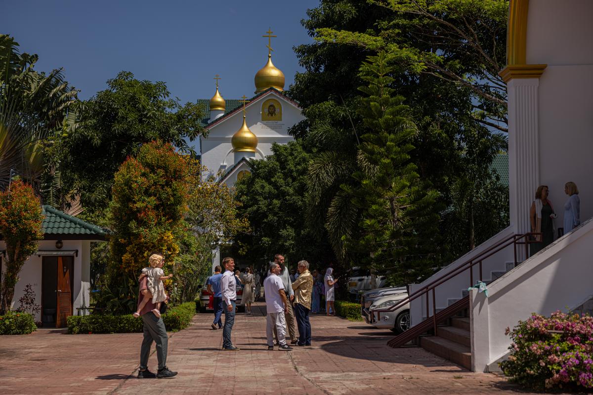 Parishioners outside the Holy Trinity Church in Phuket, Thailand after a Russian Orthodox Mass on March 8, 2026. As Phuket's Russian community has grown, so has local resentment over Russians amassing properties, opening businesses and -- critics say -- abusing the country's visa policy to work illegally. (Lauren DeCicca/The New York Times)..