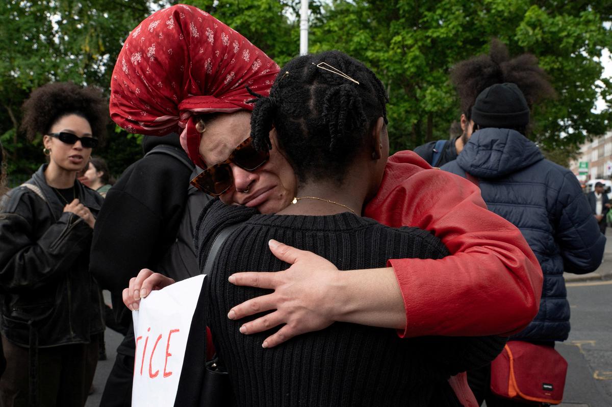 People hug during a protest following the death of Yves Sakila, a Congolese-born man who died after being restrained by security guards outside a department store, outside Leinster House in Dublin, Ireland, May 21, 2026. REUTERS/Natalia Campos