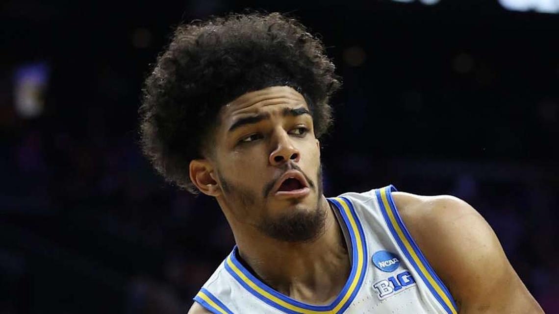  Mar 20, 2026; Philadelphia, PA, USA; UCLA Bruins guard Eric Freeny (8) makes a pass against UCF Knights center John Bol (7) in the second half during a first round game of the men's 2026 NCAA Tournament at Xfinity Mobile Arena. Mandatory Credit: Bill Streicher-Imagn Images | Bill Streicher-Imagn Images 
