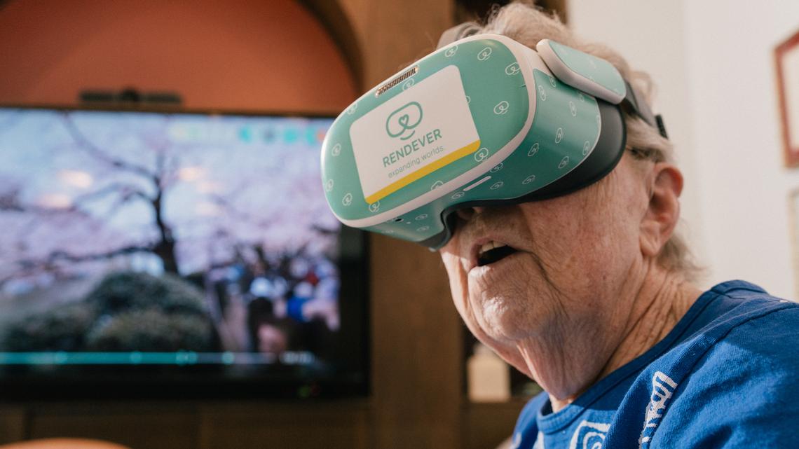 Pat Bridges watches a Japanese cherry blossom video with a VR headset in the multi purpose library at Castle Argyle in Los Angeles, Feb. 2, 2026. New tools tailored for use in senior living communities allow for shared experiences and social bonding.