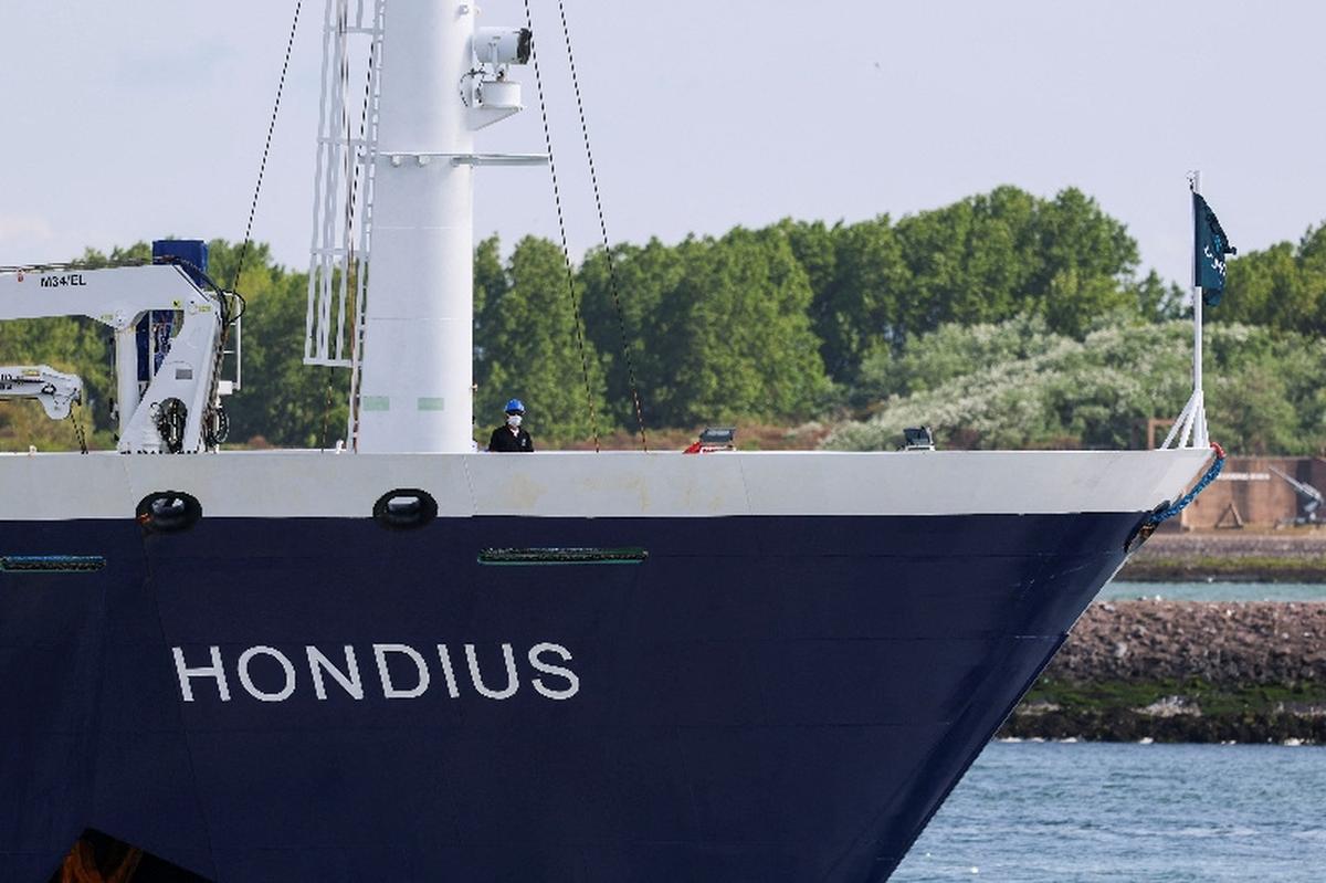 A person wears a protective mask on board the cruise ship MV Hondius, which was affected by a hantavirus outbreak, as it arrives for disinfection at the Port of Rotterdam, Netherlands, May 18, 2026. REUTERS/Yves Herman