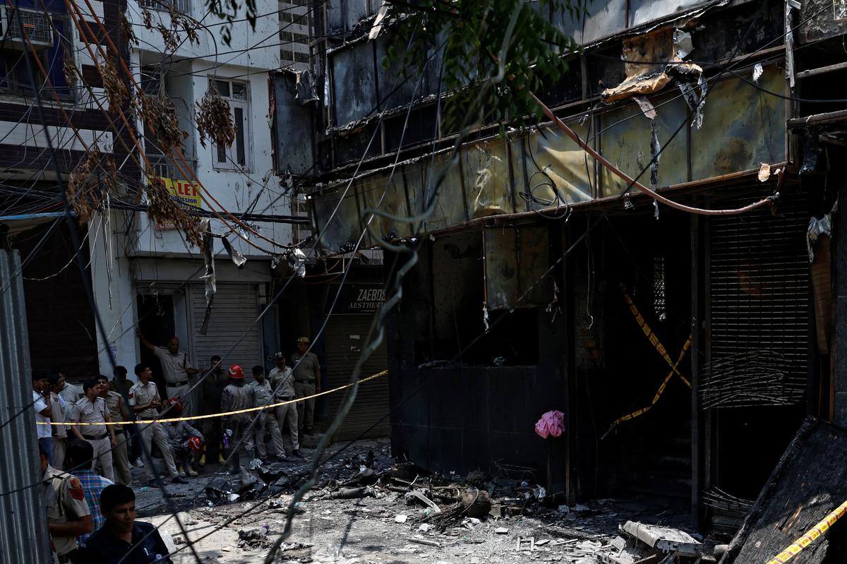 Firefighters and police officers work at the site after a fire at a hotel in New Delhi, India, June 3, 2026. REUTERS/Adnan Abidi