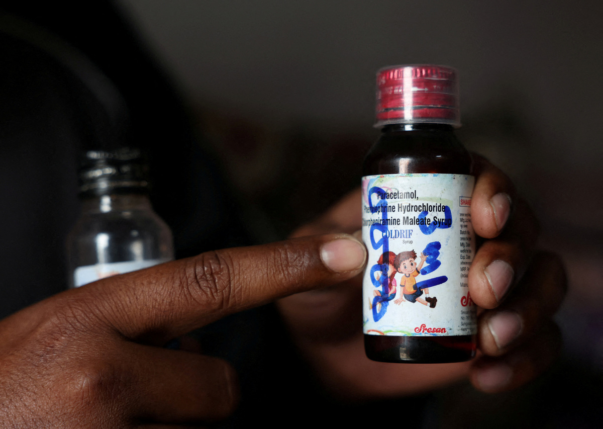 FILE PHOTO: Saddam Mansuri shows a bottle of Coldrif cough syrup, which has been linked to the deaths of multiple children and which he had been giving to his one-year-old child, in Parasia, Madhya Pradesh, India, October 10, 2025.  REUTERS/Priyanshu Singh/File Photo