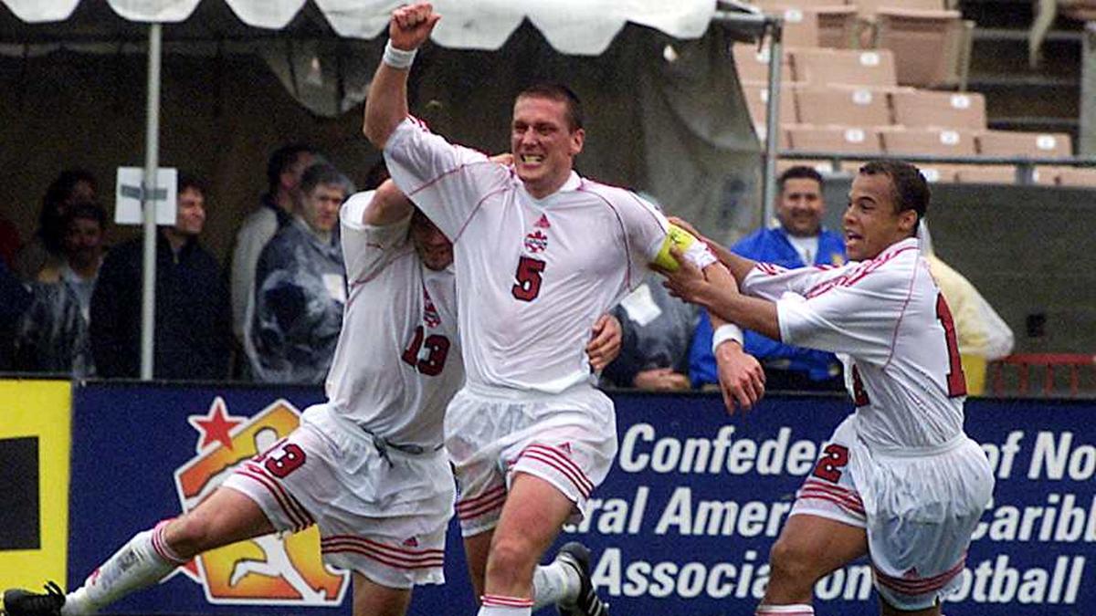  Jason Devos (center) celebrates scoring for Canada at the 2000 Concacaf Gold Cup. | VINCE BUCCI/AFP/Getty Images 