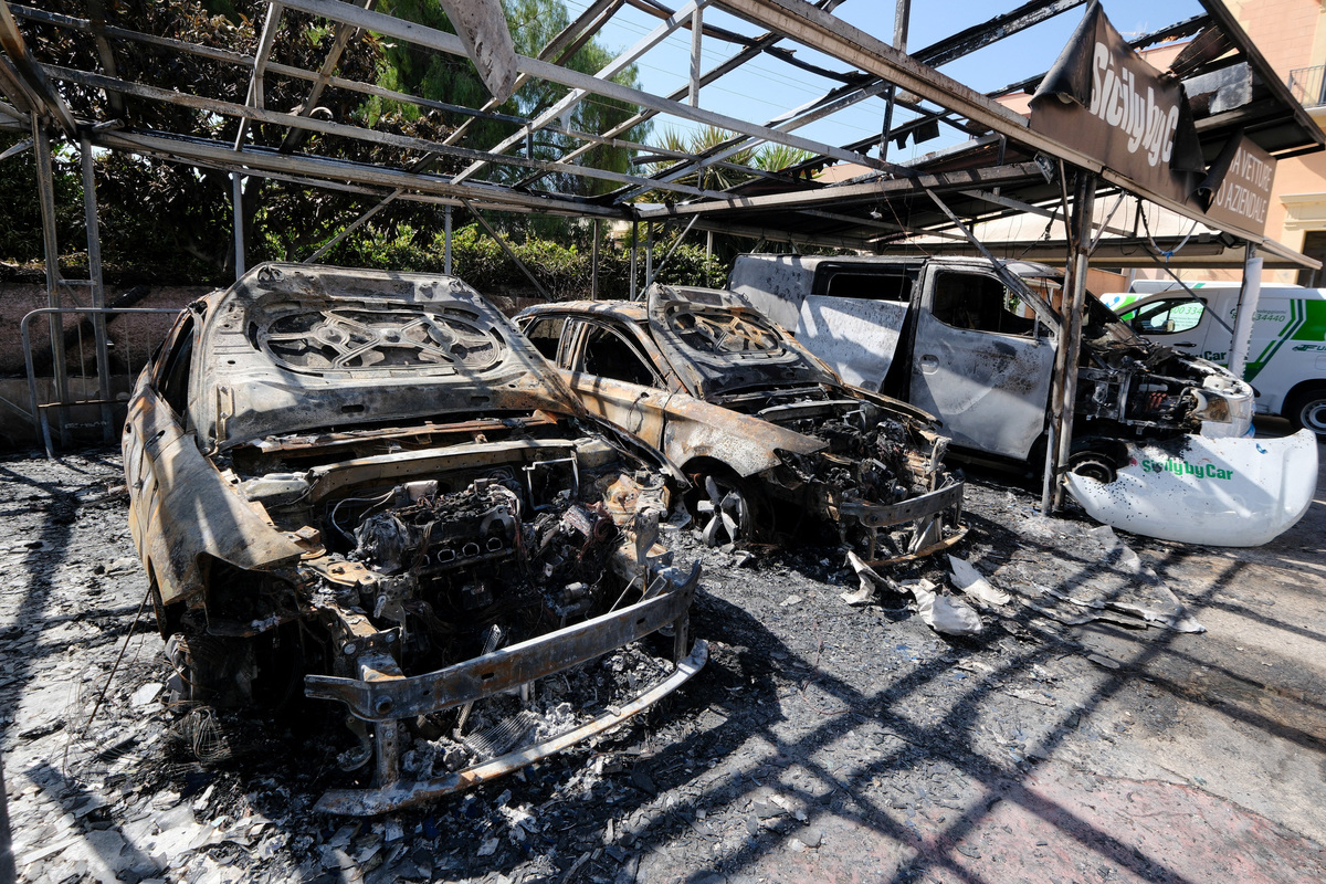 Burned vehicles are parked at a depot of Italian car rental company Sicily by Car after an arson attack, in the San Lorenzo district of Palermo, Sicily, Italy, June 11, 2026. REUTERS/Igor Petyx