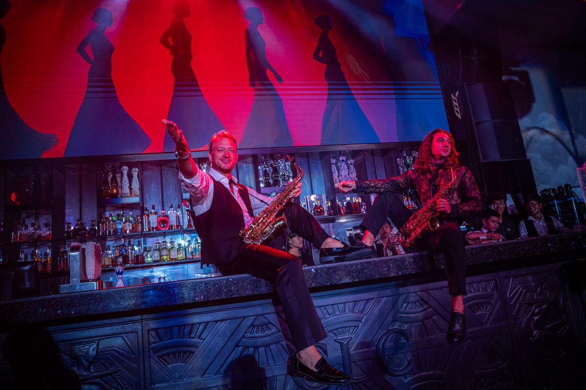 Russian-language performers at Come Leo Come, a supper club catering to expats in Bang Tao, Phuket, Thailand on March 8, 2026. Thousands who fled Russia after the invasion of Ukraine have built an enclave in Phuket, where an air of impermanence hangs over their community. (Lauren DeCicca/The New York Times)..