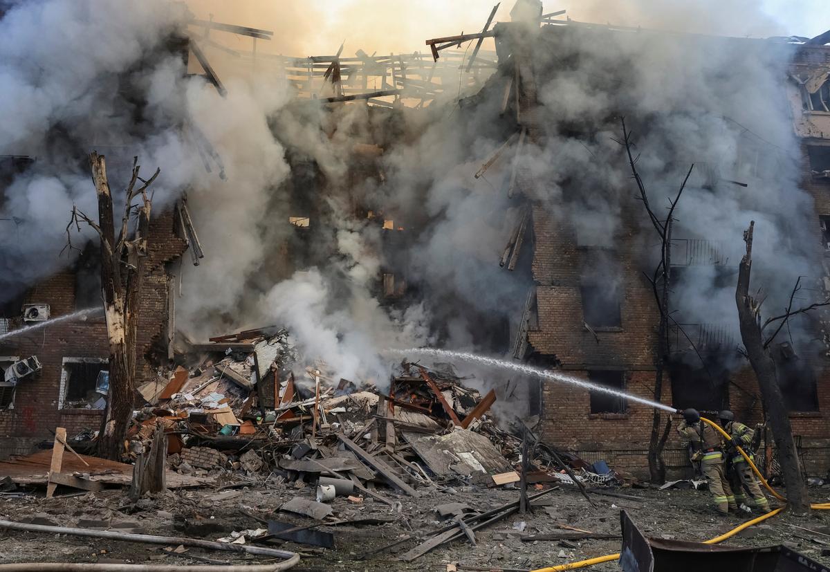Firefighters work at the site of an apartment building destroyed by a Russian missile and drone strike, amid Russia's attack on Ukraine, in Kyiv, Ukraine, May 24, 2026. REUTERS/Stringer