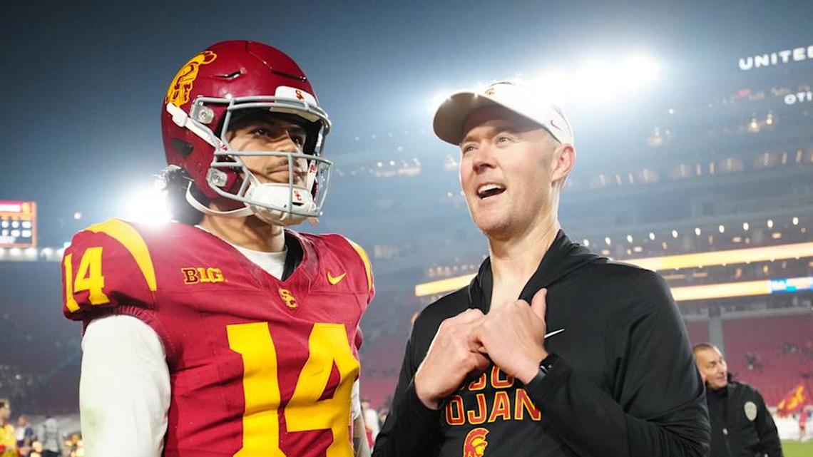 Nov 29, 2025; Los Angeles, California, USA; Southern California Trojans quarterback Jayden Maiava (14) and head coach Lincoln Riley react after the game against the UCLA Bruins at United Airlines Field at Los Angeles Memorial Coliseum. Mandatory Credit: Kirby Lee-Imagn Images | Kirby Lee-Imagn Images 