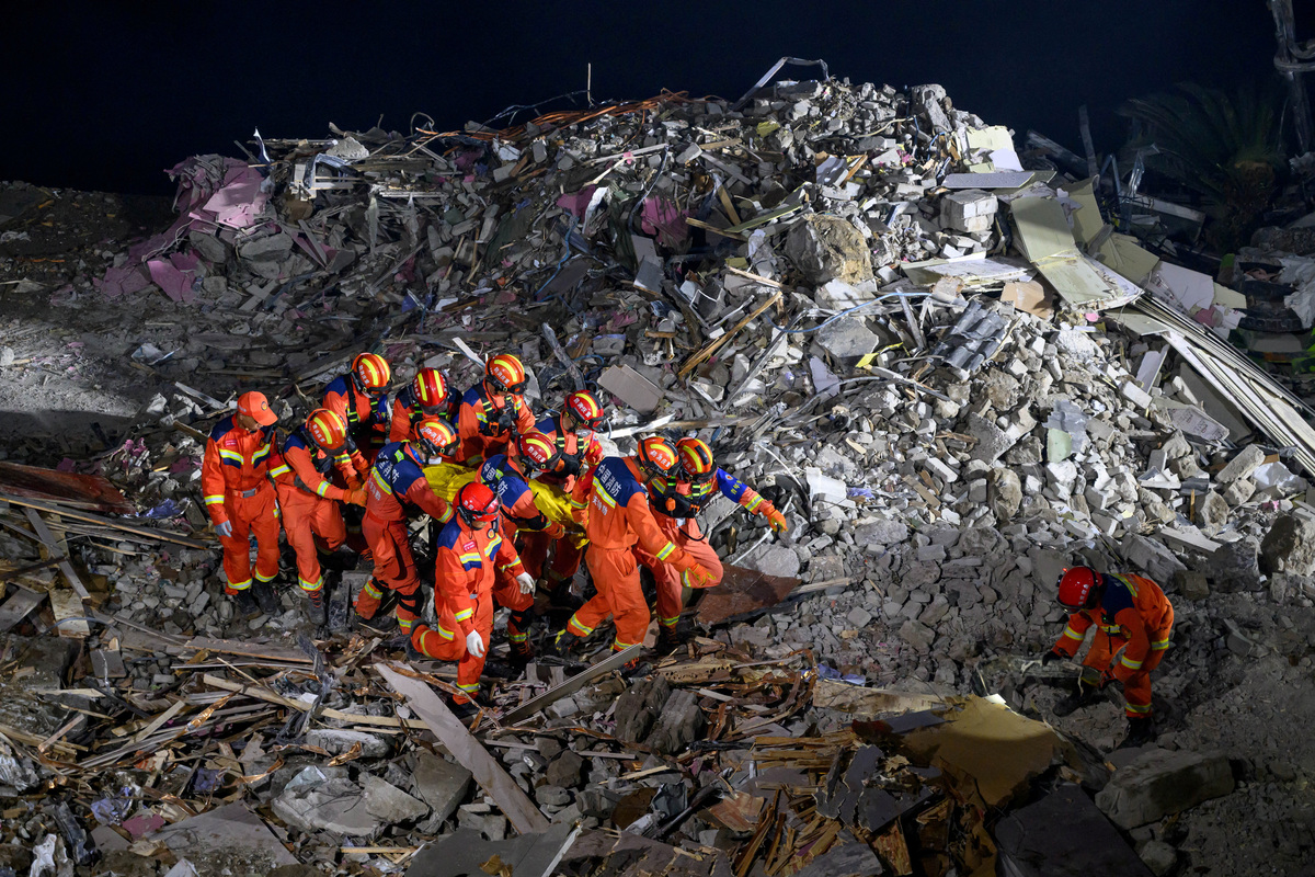 Rescue workers carry a casualty as they search for survivors at the site of a landslide along Wujiang river in Pengshui Miao and Tujia Autonomous County, Chongqing, China July 17, 2026. cnsphoto via REUTERS