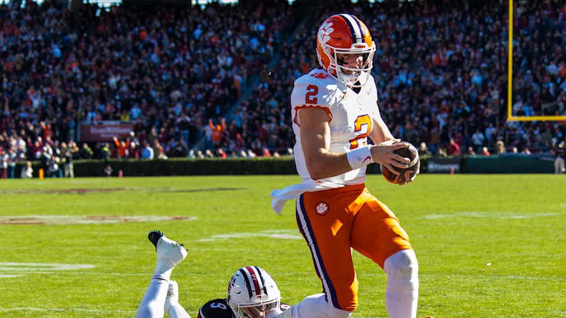 Nov 29, 2025; Columbia, South Carolina, USA; Clemson Tigers quarterback Cade Klubnik (2) rushes for a touchdown past South Carolina Gamecocks defensive back Judge Collier (8) in the second quarter at Williams-Brice Stadium. Mandatory Credit: Jeff Blake-Imagn Images | Jeff Blake-Imagn Images 