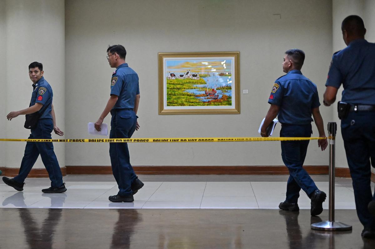 Policemen walk near the site where gunshots were heard at the Philippine Senate on Wednesday, in Pasay City, Metro Manila, Philippines, May 14, 2026. REUTERS/Noel Celios