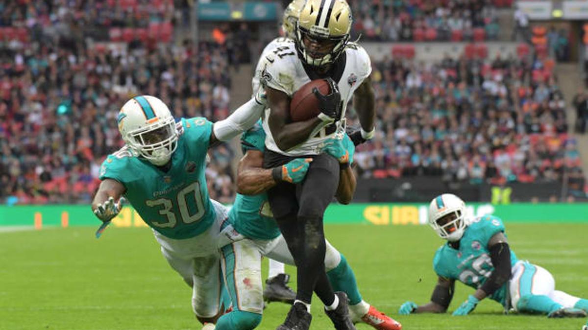 Oct 1, 2017; London, United Kingdom; New Orleans Saints running back Alvin Kamara (41) gets past Dolphins cornerback Cordrea Tankersley (30) and safety Nate Allen (29) on a 12-yard touchdown reception at Wembley Stadium. Mandatory Credit: Kirby Lee-USA TODAY Sports