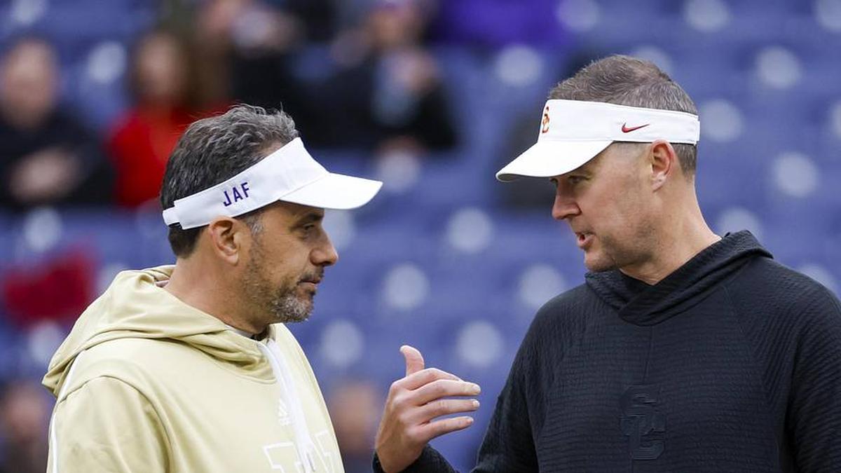  Nov 2, 2024; Seattle, Washington, USA; Washington Huskies head coach Jedd Fisch, left, talks with USC Trojans head coach Lincoln Riley during pregame warmups at Alaska Airlines Field at Husky Stadium. Mandatory Credit: Joe Nicholson-Imagn Images | Joe Nicholson-Imagn Images 