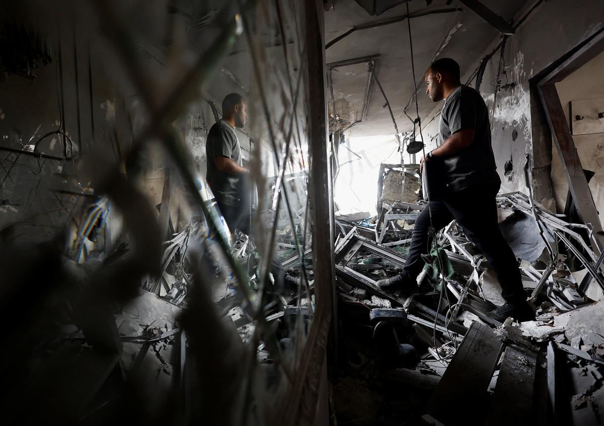 A Palestinian man inspects the site of an Israeli airstrike on a residential building on Tuesday, in Gaza City, May 27, 2026. REUTERS/Mahmoud Isaa