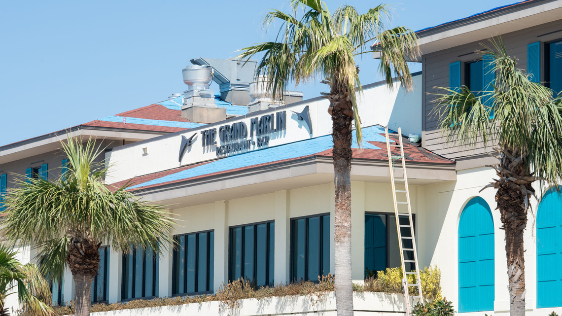Pensacola Beach standoff: Roofers refuse to come down for ICE agents 