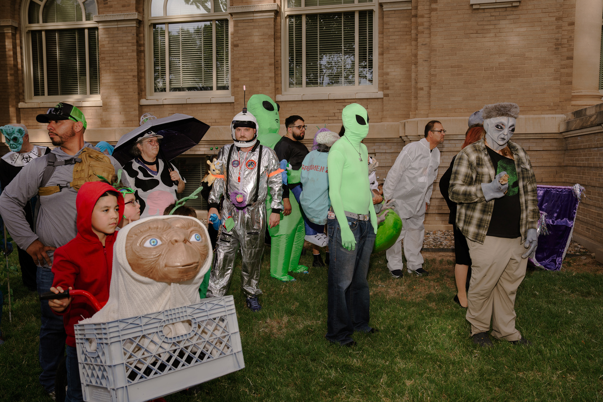 Participants in the Roswell UFO festival costume contest wait to be judged in Roswell, N.M, July 3, 2026. Downtown Roswell streetlights are painted to look like aliens and little green men stand sentry outside carwashes and banks, all a homage to the purported UFO crash in 1947 known as the Roswell Incident. (Paul Ratje/The New York Times)