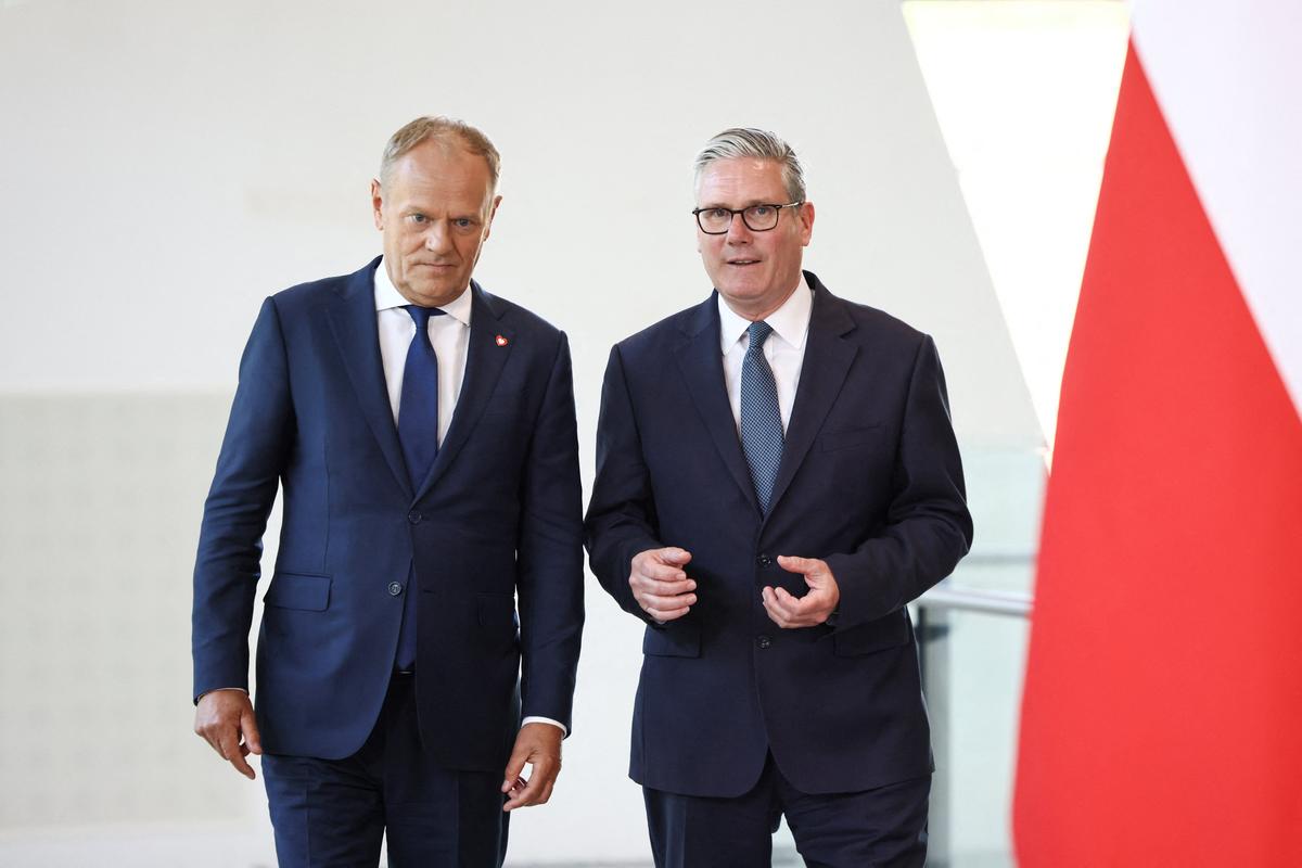 Britain's Prime Minister Keir Starmer and Polish Prime Minister Donald Tusk talk as they attend a signing ceremony of UK-Poland defence and security treaty at the Battle of Britain Bunker in Uxbridge, Britain, May 27, 2026. REUTERS/Jack Taylor/Pool
