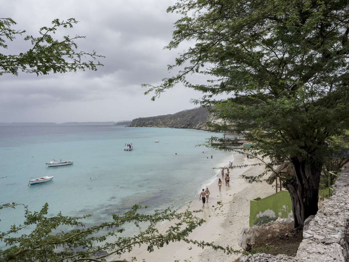Visitors at Boka Sami beach in Curacao, June 7, 2026. Competing for the first time in the World Cup soccer tournament, Curacao is brimming with joy. (Luis Antonio Rojas/The New York Times)