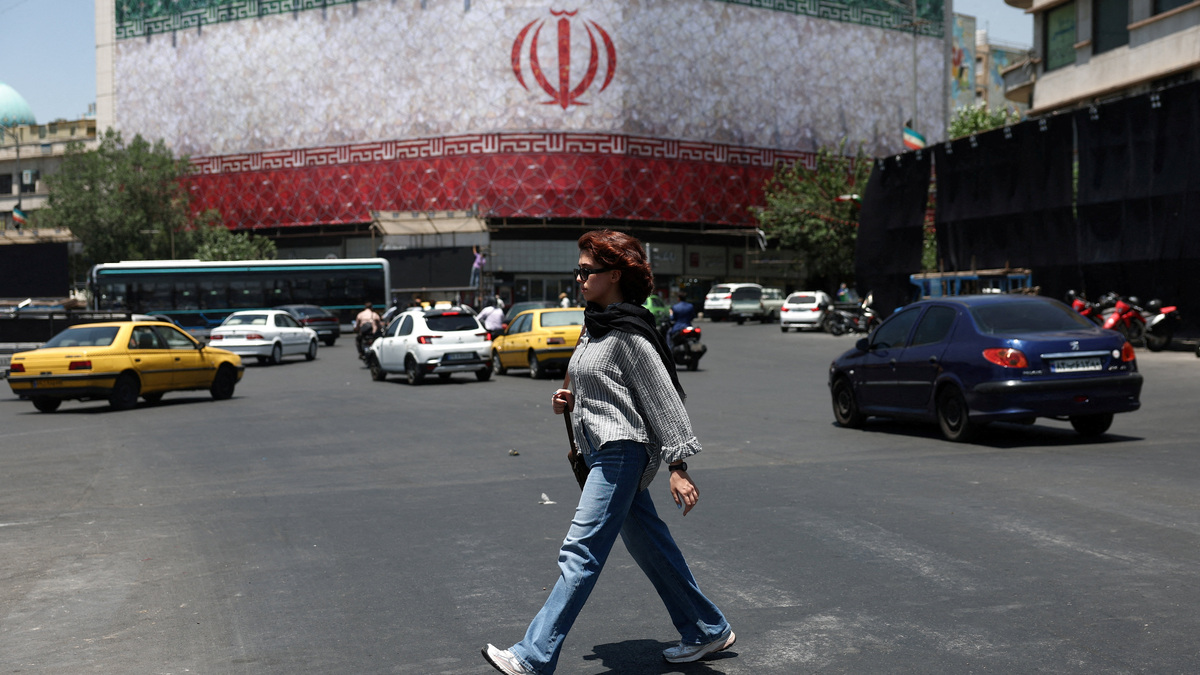 A woman walks on a street in Tehran, Iran, June 14, 2026. Majid Asgaripour/WANA (West Asia News Agency) via REUTERS