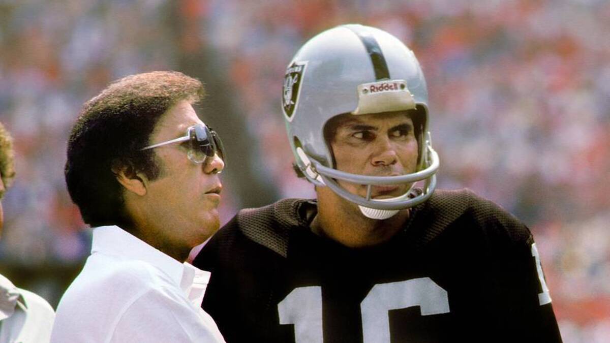  1982; Unknown location, USA; FILE PHOTO; Los Angeles Raiders head coach Tom Flores talks with quarterback Jim Plunkett (16) on the sideline during the 1982 season. Mandatory Credit: Manny Rubio-USA TODAY Network | Manny Rubio-Imagn Images 