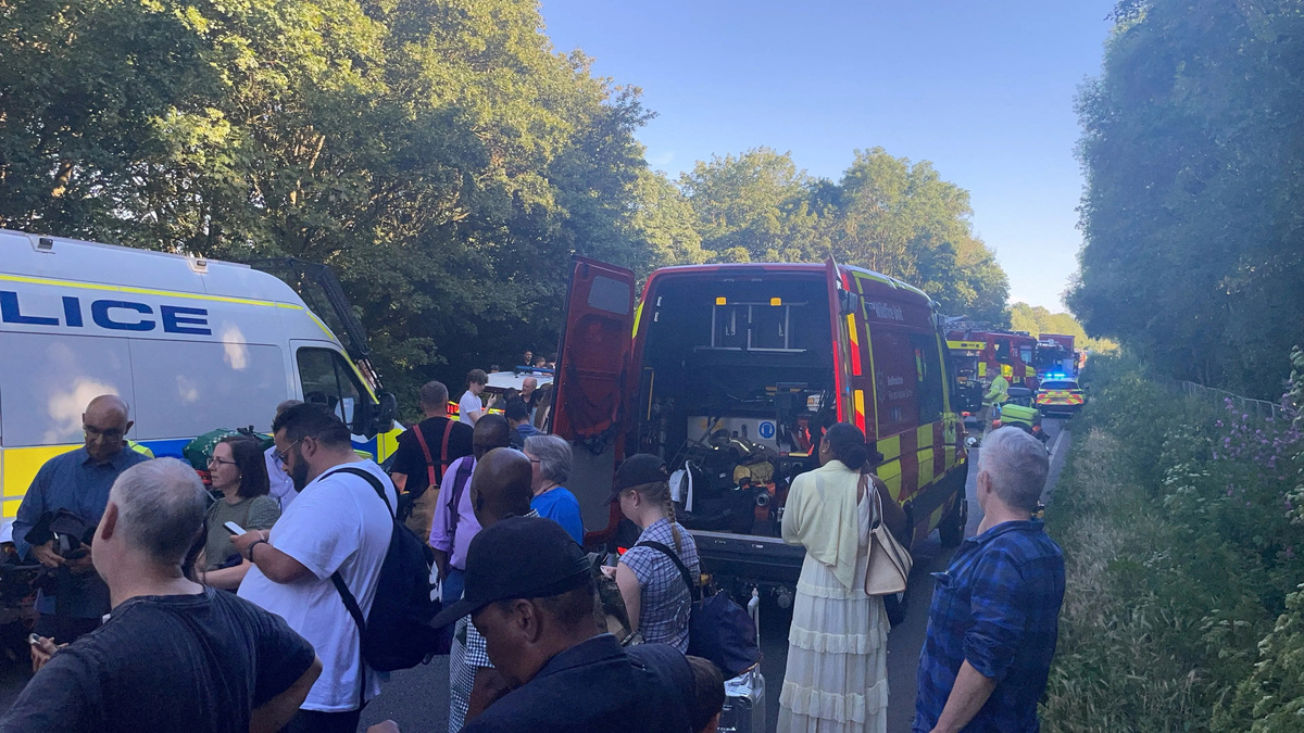 People and emergency service workers gather near the scene of a collision involving two trains near Bedford, Britain, June 19, 2026. Dr Pete Knapp/via REUTERS