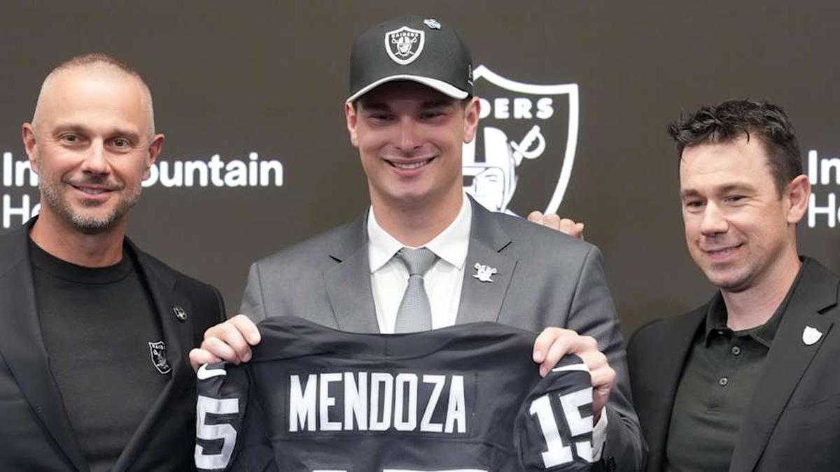 Apr 24, 2026; Henderson, NV, USA; Las Vegas Raiders quarterback Fernando Mendoza (center) poses with general manager John Spytek (left) and head coach Klint Kubiak at introductory press conference at Intermountain Health Performance Center after being selected as the No. 1 pick in the 2026 NFL Draft. Mandatory Credit: Kirby Lee-Imagn Images | Kirby Lee-Imagn Images 