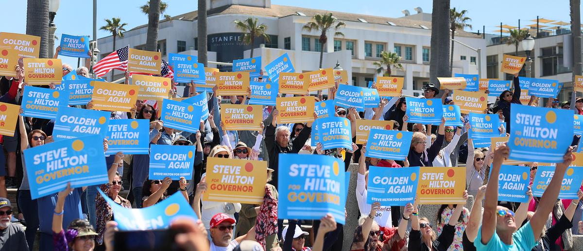 Supporters cheer and hold up signs as conservative commentator and Silicon Valley entrepreneur Steve Hilton announces his campaign for California governor at the Pier Plaza in Huntington Beach on Tuesday, April 22, 2025.