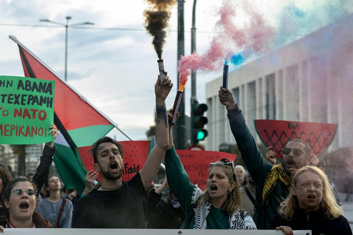  Protesters in Athens, Greece hold flares as they take part in action against NATO and the U.S. and Israeli war against Iran. AP Photo/Yorgos Karahalis 