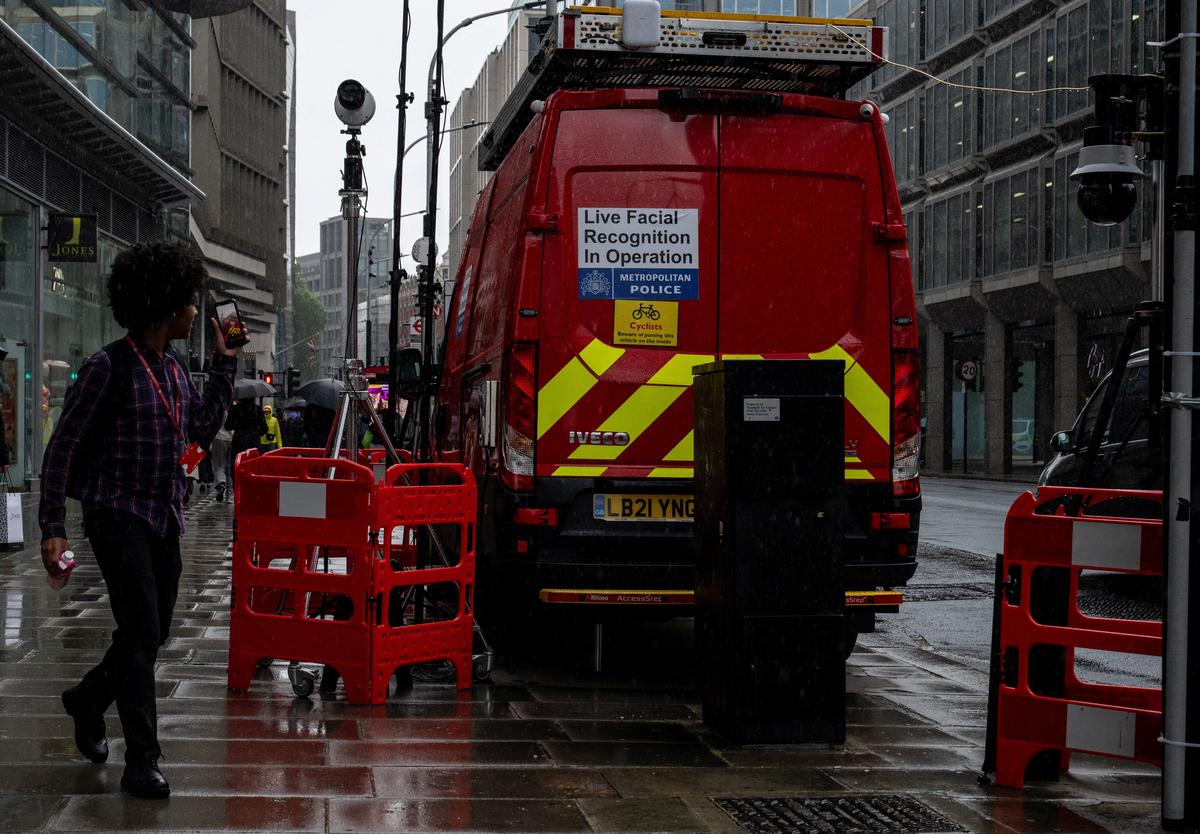 A pedestrian uses their phone to film a Metropolitan Police live facial recognition operation in London, Britain, May 11, 2026. REUTERS/Chris J. Ratcliffe