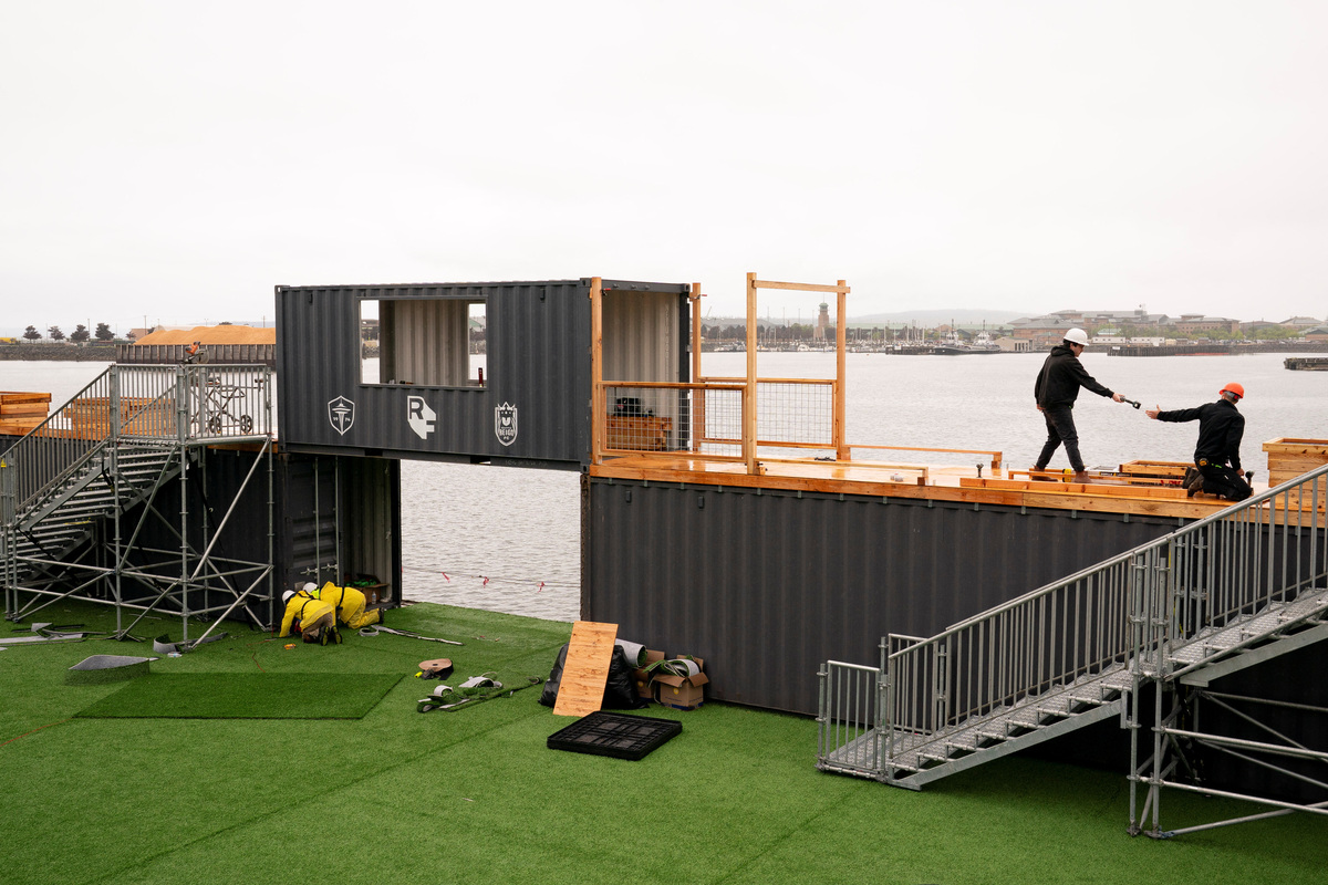 Workers construct a floating pitch and event space on a barge, dubbed the Seattle Soccer Celebration, which will be home to watch parties and events organized and hosted by Seattle Sounders FC, Seattle Reign FC, and RAVE Foundation while located on the Seattle waterfront during the FIFA World Cup 2026, in Everett, Washington, U.S., June 4, 2026. REUTERS/David Ryder