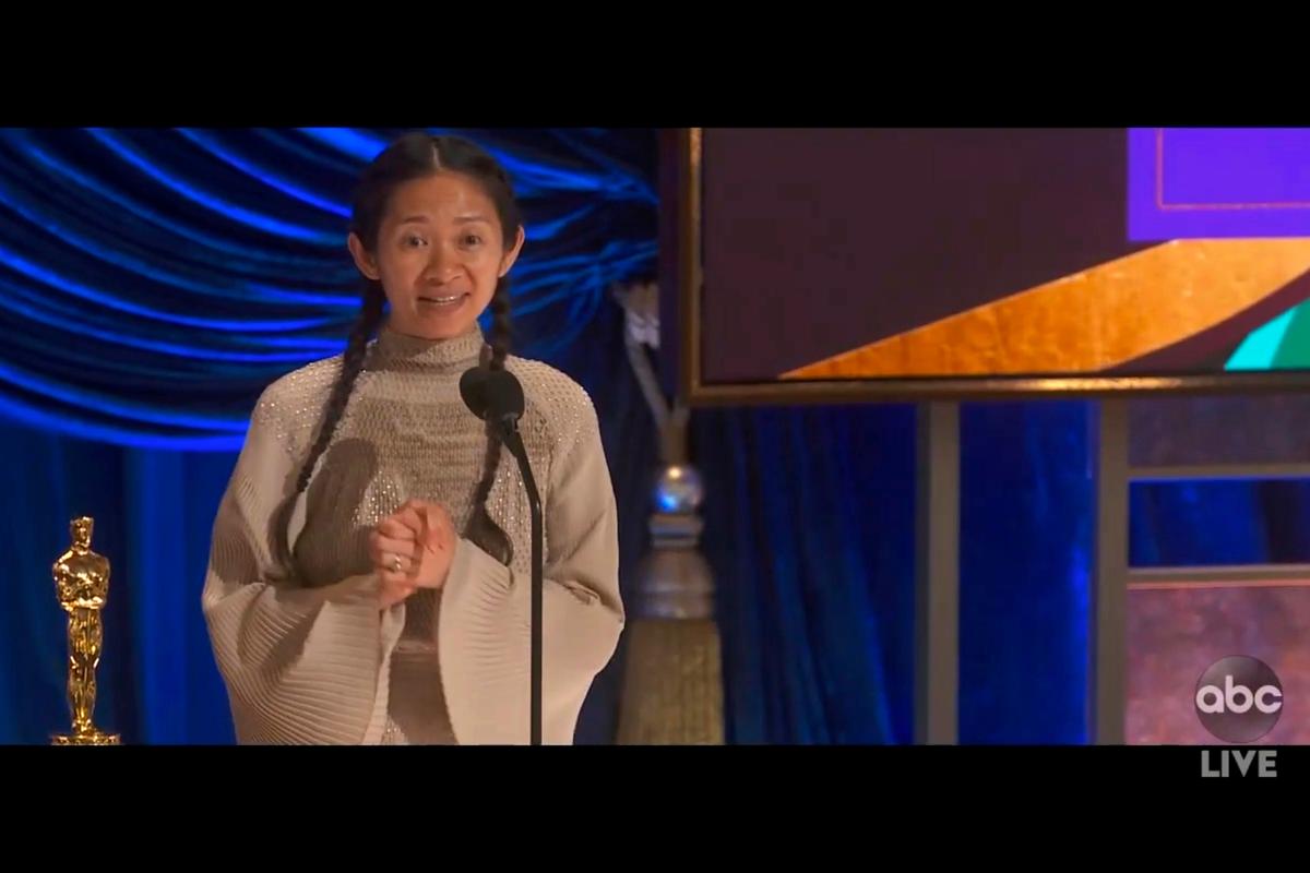 Chloé Zhao accepts the award for best director for “Nomadland” at the Oscars on Sunday. Later in the evening, she’d return to the stage to accept best picture.
